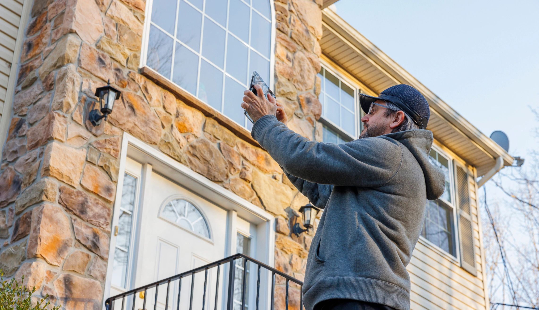 Home inspector reviewing a property exterior.