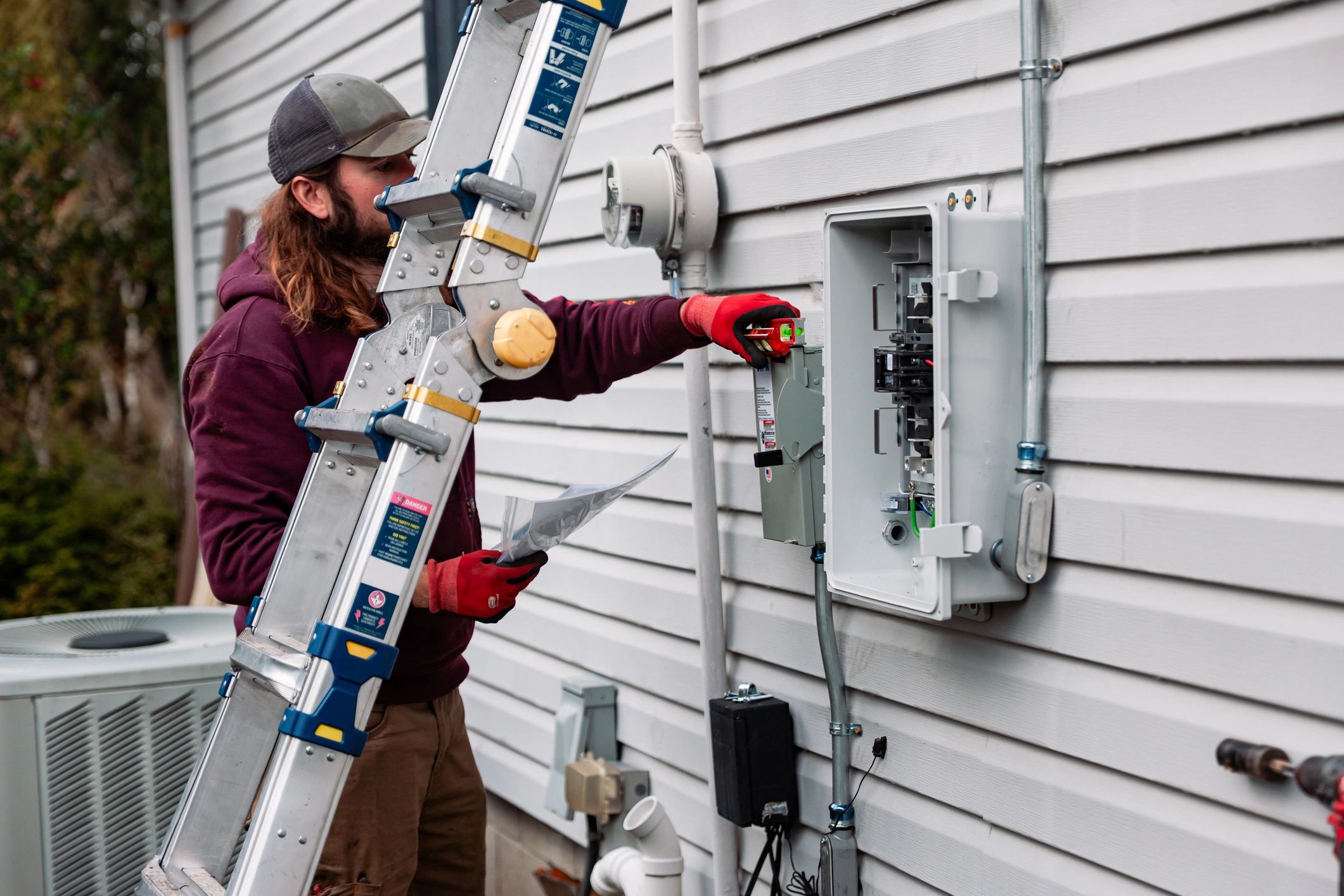 Technician working on the exterior of a home